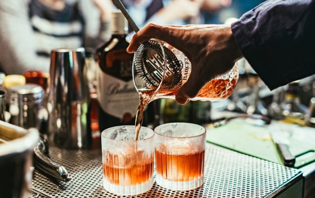 bartender straining drink