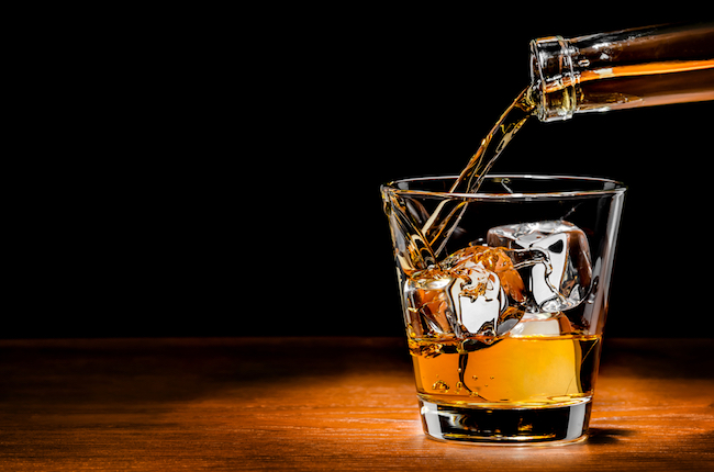 pouring whiskey on the rocks