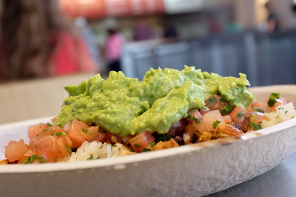 Guacamole sits on a dish at a Chipotle restaurant on March 5, 2014 in Miami, Florida. The Mexican fast food chain is reported to have tossed around the idea that it would temporarily suspend sales of guacamole due to an increase in food costs.  (Photo by Joe Raedle/Getty Images)