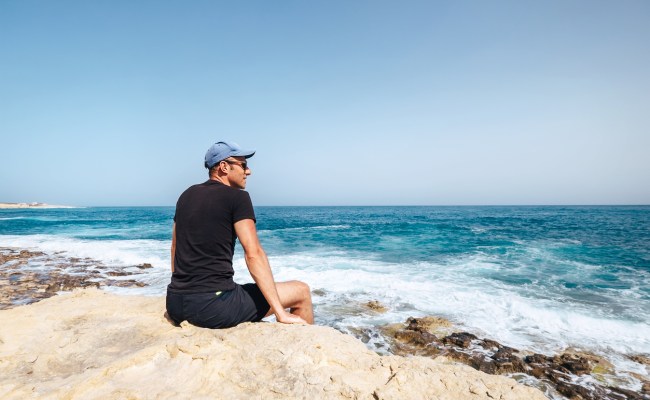 man looking at ocean
