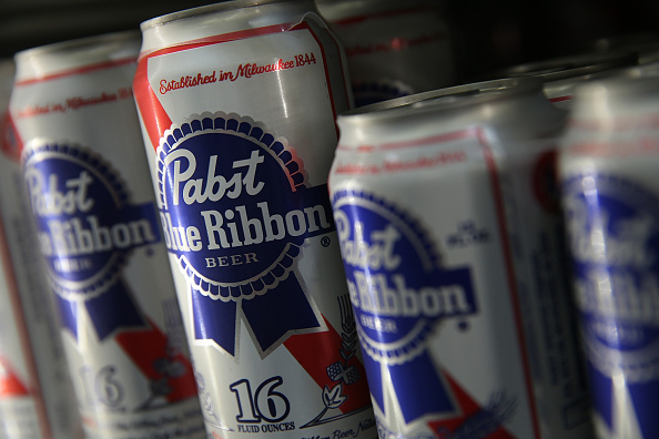 SAN FRANCISCO, CA - SEPTEMBER 22: Cans of Pabst Blue Ribbon beer sit on a shelf at a convenience store on September 22, 2014 in San Francisco, California. Pabst Brewing Co., the maker of Pabst Blue Ribbon announced that they are selling their company to Russian company Oasis Beverages for an undisclosed sales price. (Photo by Justin Sullivan/Getty Images)