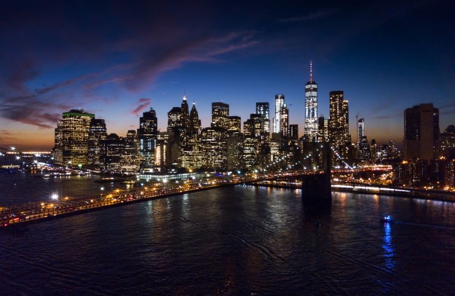 Aerial view of Brooklyn bridge and New York cityscape at night