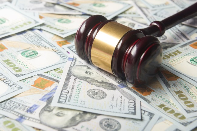 Auctioneer gavel on pile of cash