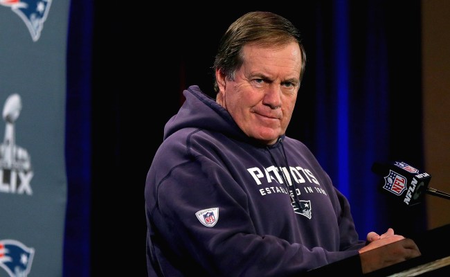 Bill Belichick Adjusting Microphones Before Speaking At The Podium