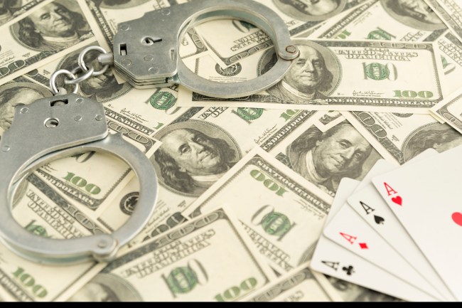 illegal gambling money handcuffs cards
