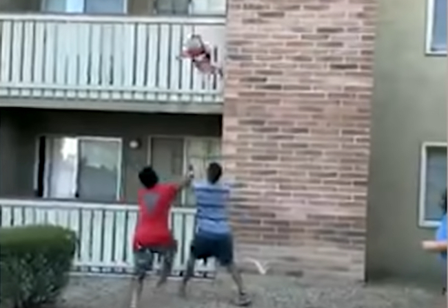 Football player catches toddler