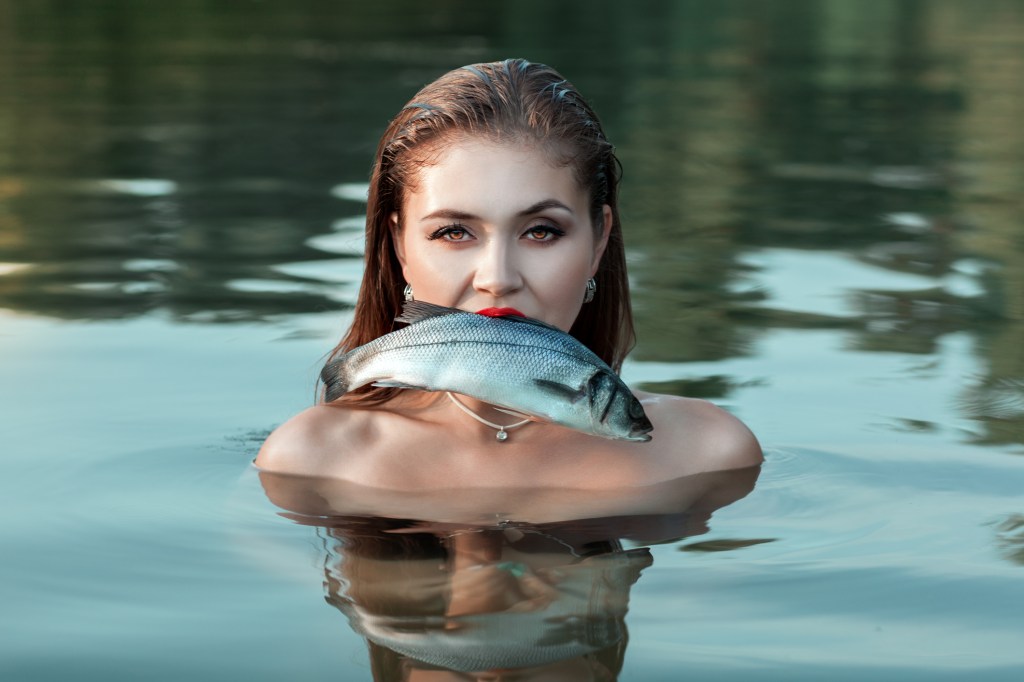 girl with fish in her mouth
