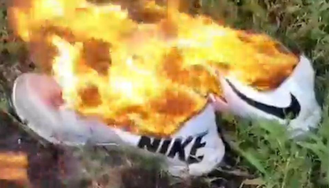burning nike satan shoes protest