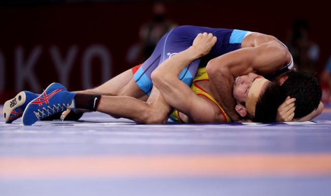 CHIBA, JAPAN - AUGUST 04: Nurislam Sanayev of Team Kazakhstan competes against Kumar Ravi of Team India during the Men’s Freestyle 57kg Semi Final on day twelve of the Tokyo 2020 Olympic Games at Makuhari Messe Hall on August 04, 2021 in Chiba, Japan.