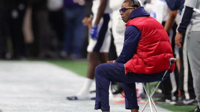 Deion Sanders sits on the sidelines.