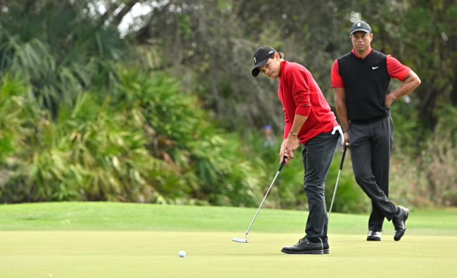 charlie woods putts with tiger watching