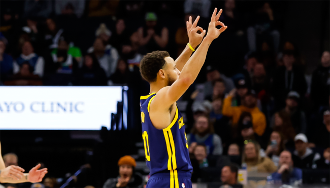steph curry holding up 3 sign
