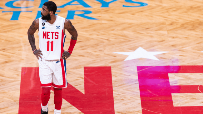 Kyrie Irving stands at midcourt.