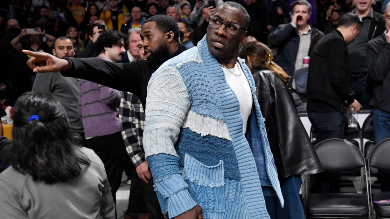 Shannon Sharpe sitting courtside