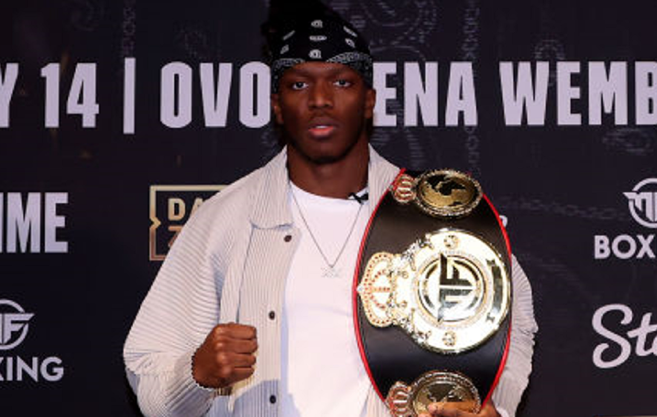 KSI posing with his belt