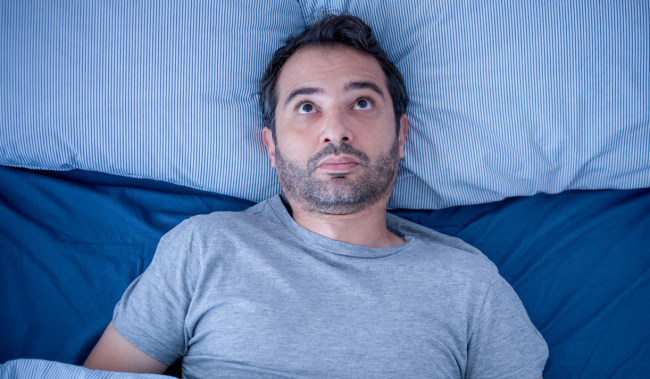 man in bed cant sleep