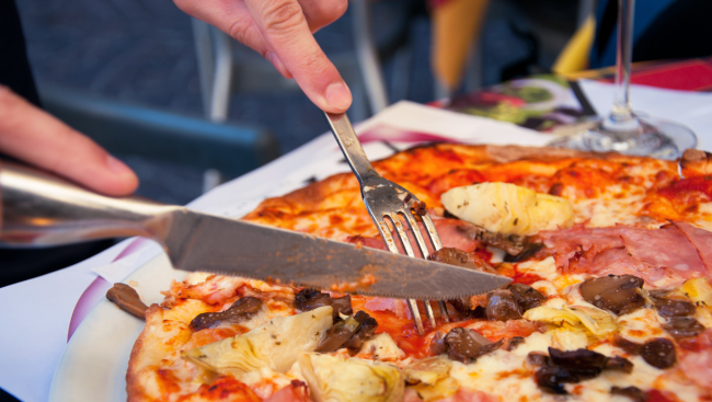 person eating pizza with knife and fork why