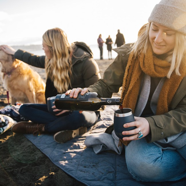 Woman pouring wine in a YETI Rambler Wine Tumbler