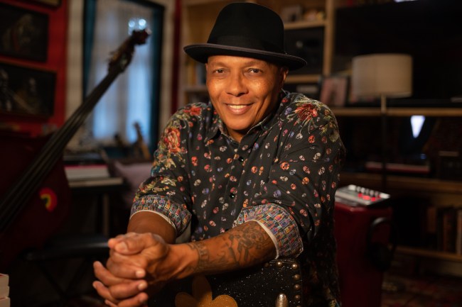 New Orleans music legend Ivan Neville seating in a recording studio