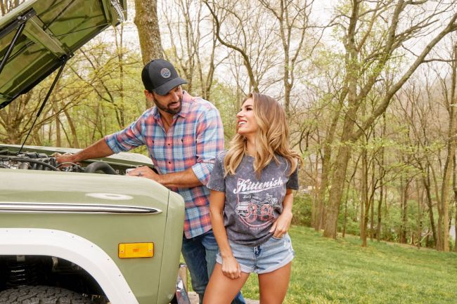 Eric Decker and his wife, Jesse James Decker pictured with the hood open on an old Ford Bronco
