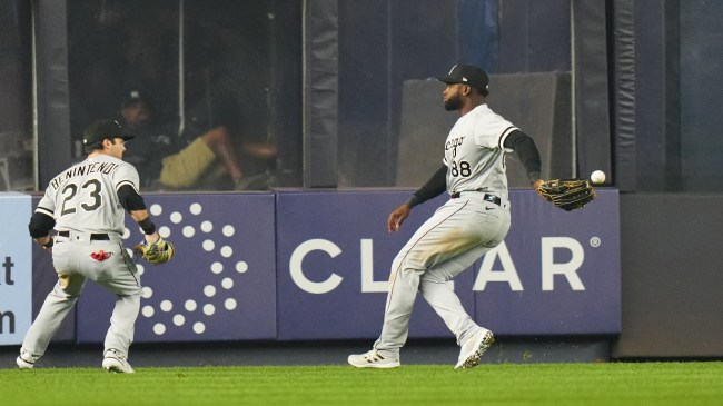 Two Chicago White Sox players watch a ball drop between them at Yankee Stadium.