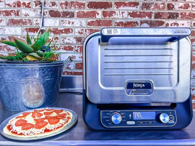 Ninja Woodfire Outdoor Oven with a pizza