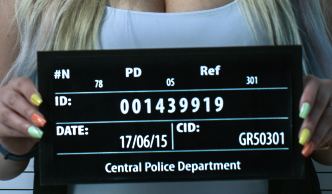 woman getting mugshot