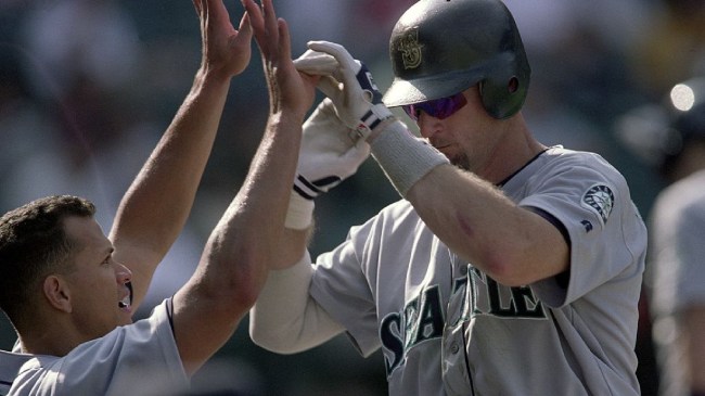 Alex Rodriguez and Jay Buhner high five in the dugout