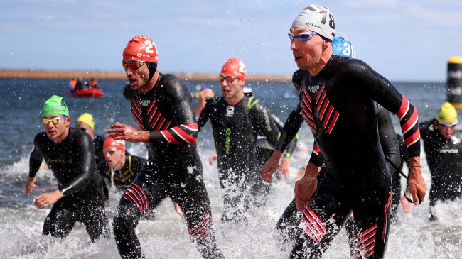 Triathlon swimmers emerging from water