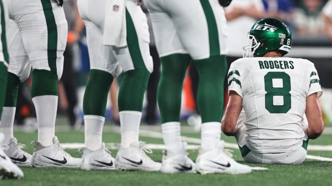 Aaron Rodgers sits on the ground after suffering an apparent injury.