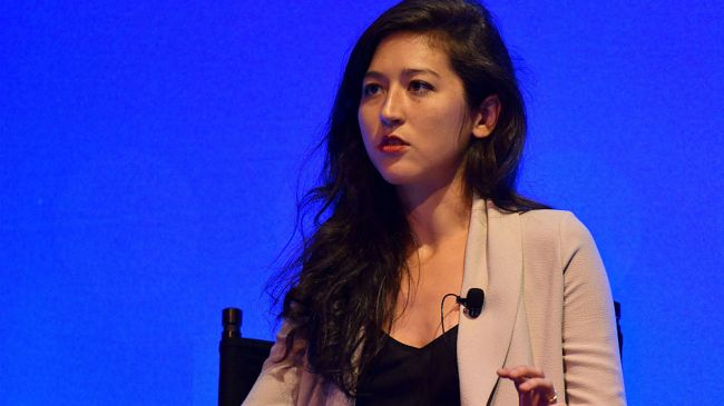 mina kimes speaking at a press conference