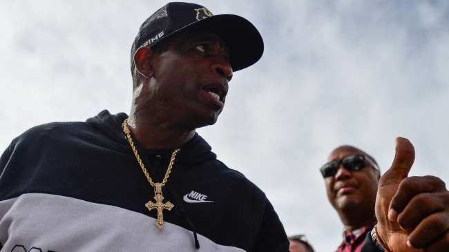 Deion Sanders talks to his team during a game against USC.