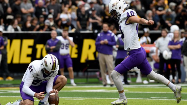 James Madison kicker Camden Wise attempts an extra point.