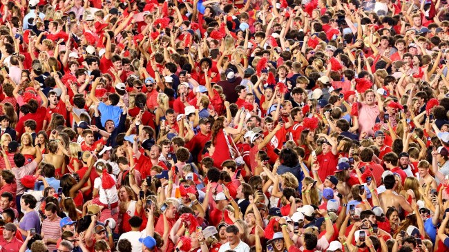 Ole Miss fans celebrate on the field after beating LSU.