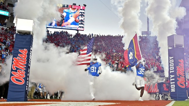 Ole Miss players run onto the field before a game against Arkansas.