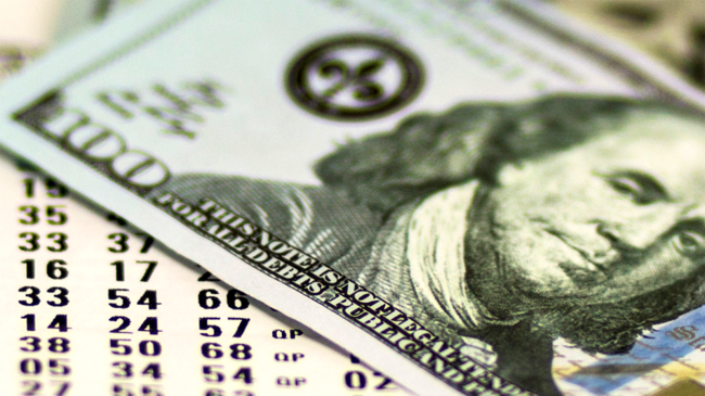 Money on top of lottery ticket