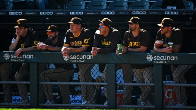 San Diego Padres team members stand in the dugout.