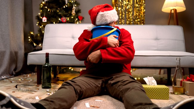 man hungover puking in bucket mew years christmas