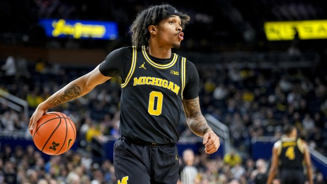 Dug McDaniel warms up before a Michigan basketball game.