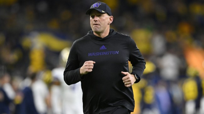 Kalen DeBoer runs on the field at the national championship.