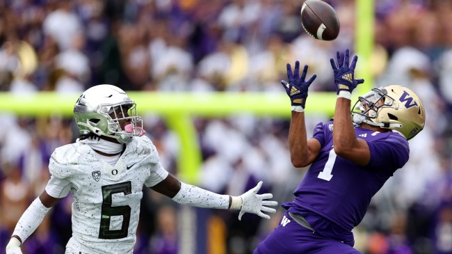 Washington WR Rome Odunze catches a pass over an Oregon defender.