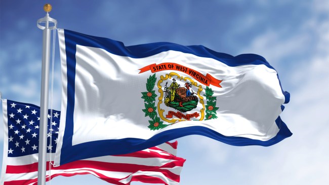 West Virginia state flag waving next to American flag