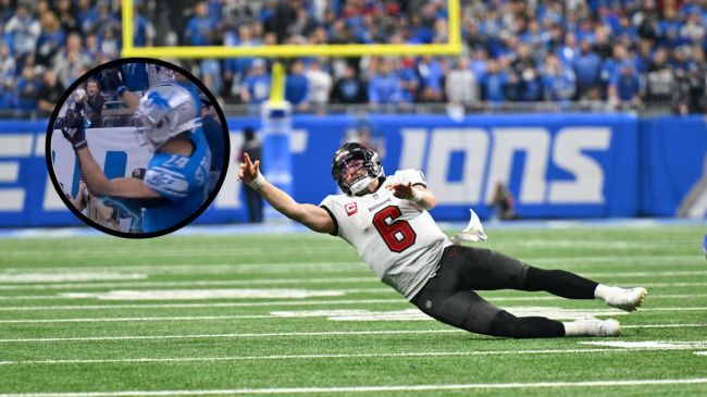baker mayfield making a throw as he falls to the ground