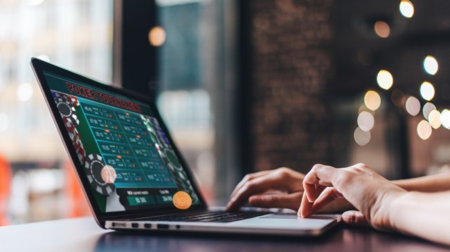 An online poker player opens a game on her computer.
