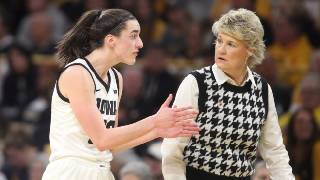 Caitlin Clark talks to coach Lisa Bluder on the court.