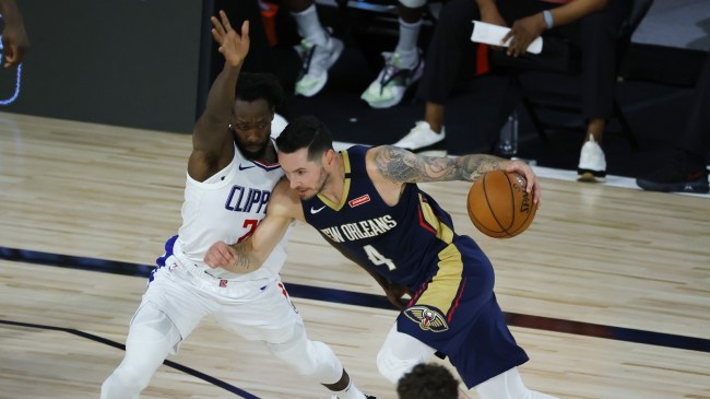 JJ Redick drives the ball as Patrick Beverley plays defense.
