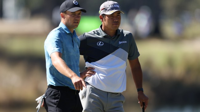 Jordan Spieth speaks to Hideki Matsuyama on the course.