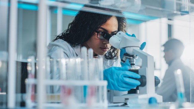 Medical Science Laboratory Scientist Looking Under Microscope