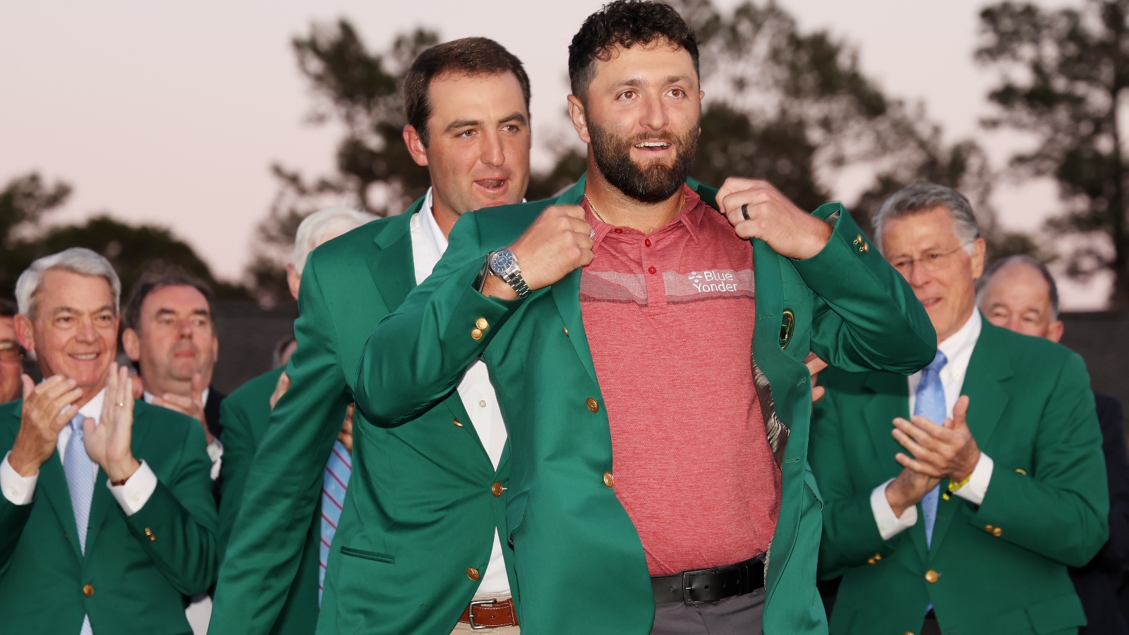 Jon Rahm putting on the Masters green jacket
