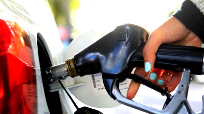woman refueling gas tank at station